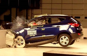 A car impacting a wall in a crash test.