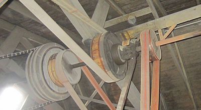 A line shaft delivering power via multiple pulleys